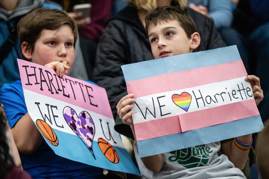 Two children hold signs in support of VIU women’s basketball forward Hariette Mackenzie at a game on Nov. 8, 2024. Photo by Mick Sweetman / The Discourse