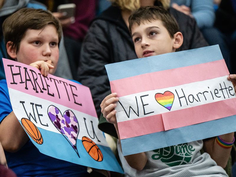Two children hold signs in support of VIU women’s basketball forward Hariette Mackenzie at a game on Nov. 8, 2024. Photo by Mick Sweetman / The Discourse