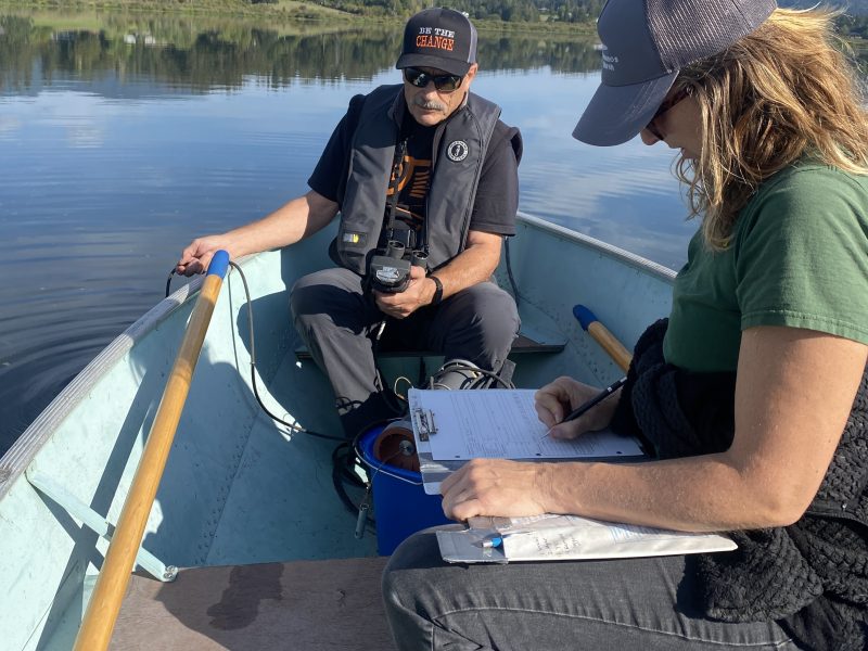 Two people sit in a boat on Somenos Lake