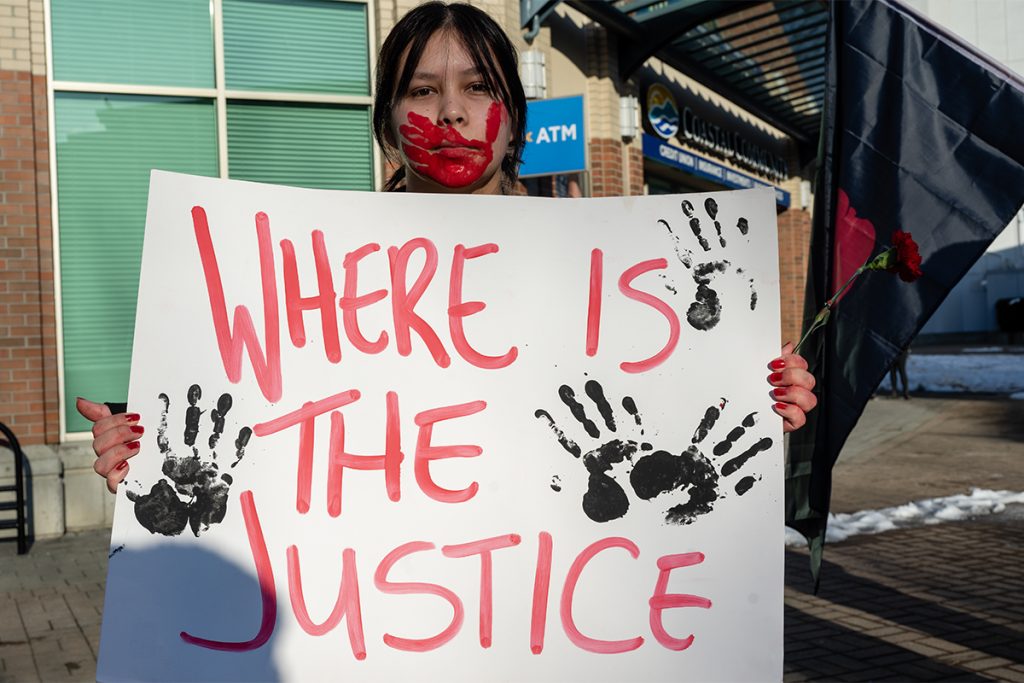 Lily Thomas, 18 from Cowichan Tribes, holds a sign calling for justice at the march for missing and murdered Indigenous women in Nanaimo on Feb. 14, 2025. Photo by Mick Sweetman / The Discourse.