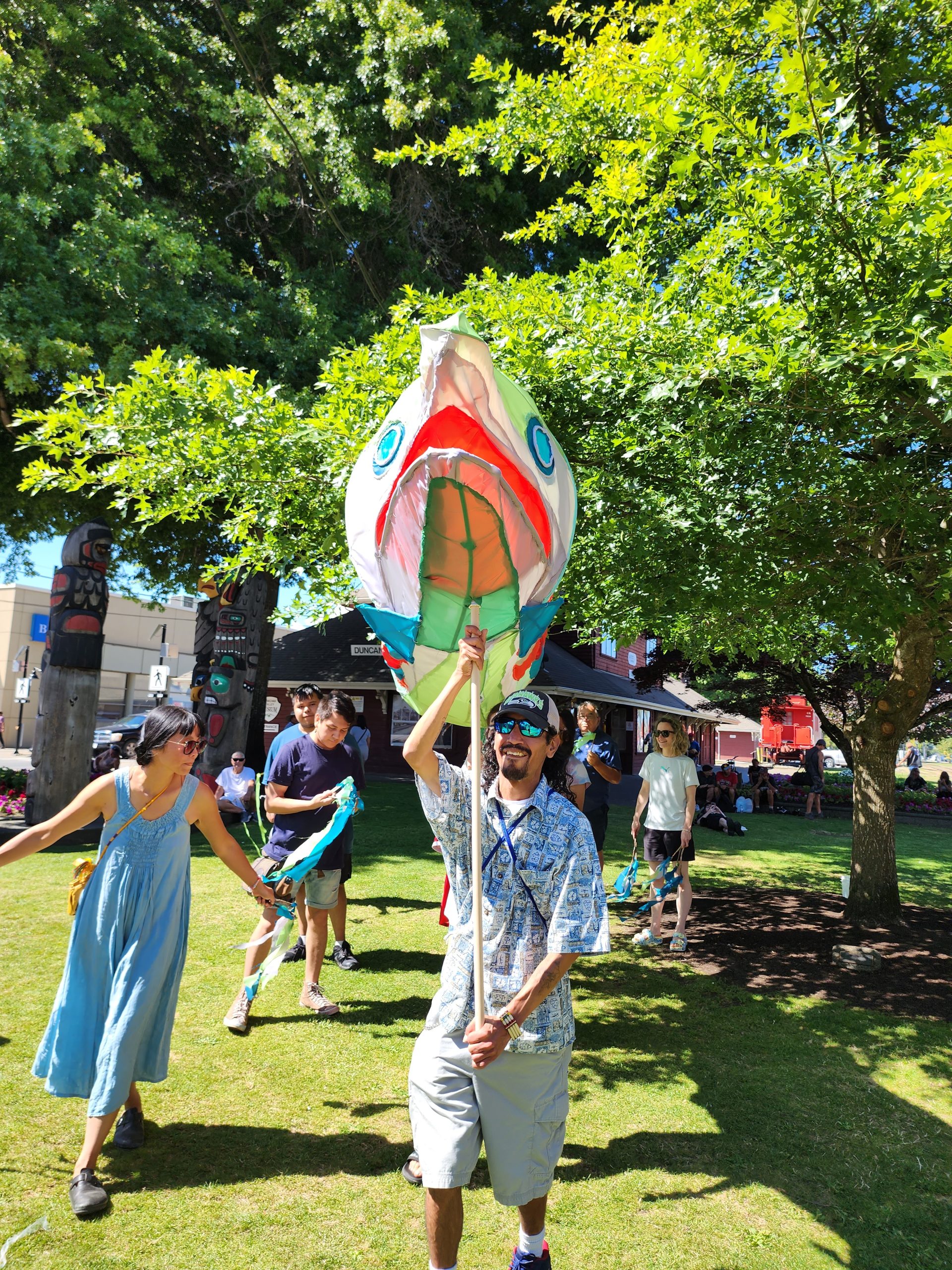 The salmon puppet makes an appearance in a crowd of people.