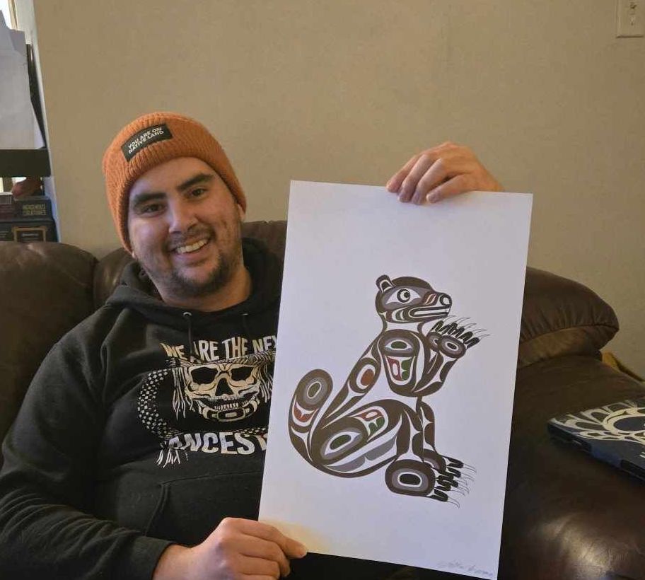 K’ómoks First Nation member Jessie Everson holds marmot artwork he made.