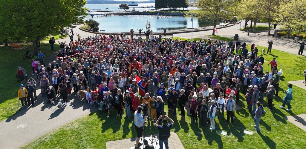 Hundreds of people from Tod's Nanaimo Infusion standing in Maffeo Sutton Park for a photo from a drone.