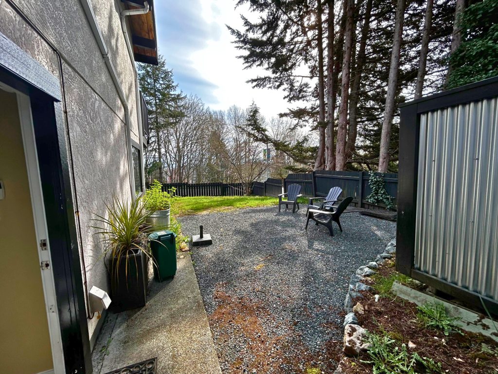 An empty yard with two chairs.