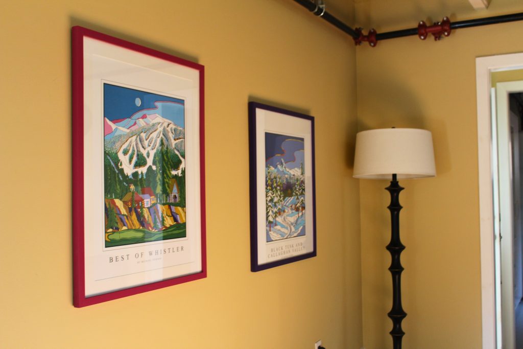 A wall with two pictures.