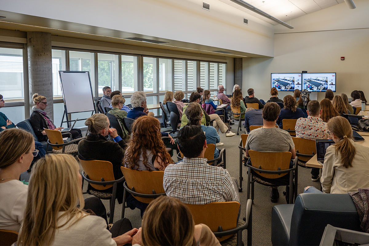 Dozens of VIU faculty and staff watch a contentious senate meeting about proposed program cancelations and suspensions on screens in an overflow room on Wednesday, May 21, 2025. Photo by Mick Sweetman / The Discourse