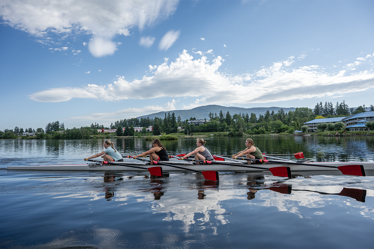 Long Lake with rowing team paddling.