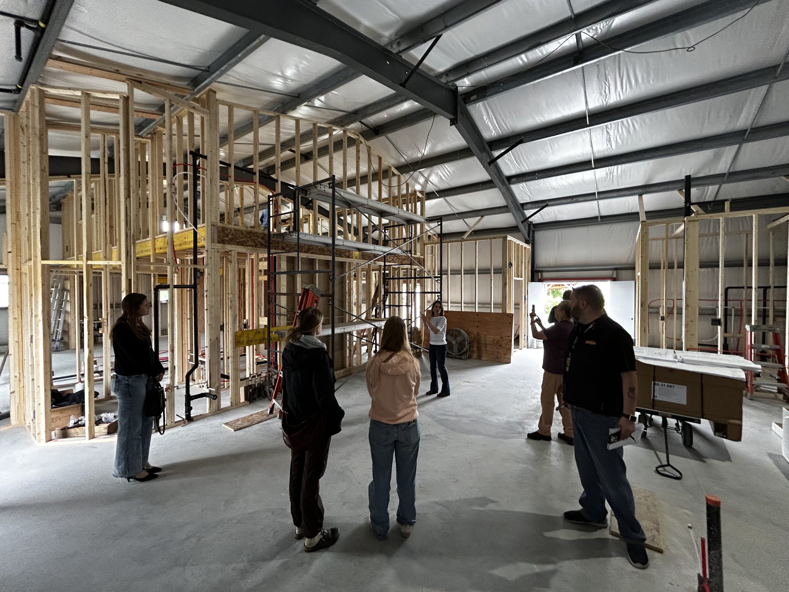 A group of people stand in a warehouse that will be used as a kitchen to help support food security in the Cowichan Valley.