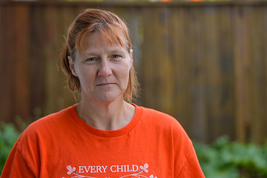 Photo of a woman wearing an orange every child matters T-shirt.