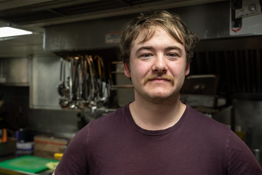 Leading Seaman Trey Pennington stands in the galley of HMCS Nanaimo where he works as one of the ship’s cooks.