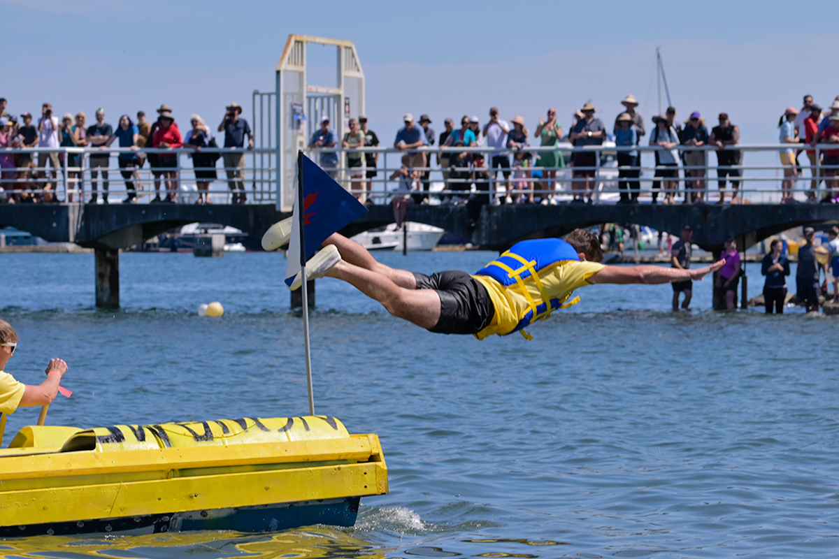 A member of the Superstore team goes for a bellyflop to end their race at the 39th annual Silly Boat Regatta on Sunday, July 20, 2025.