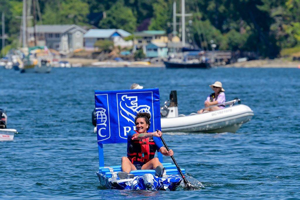 Lisa Mertin, of the Royal Bank of Canada team, paddled the course solo after her teammates could not stay on the slippery surface of their boat. Photo by Mick Sweetman / The Discourse. 
