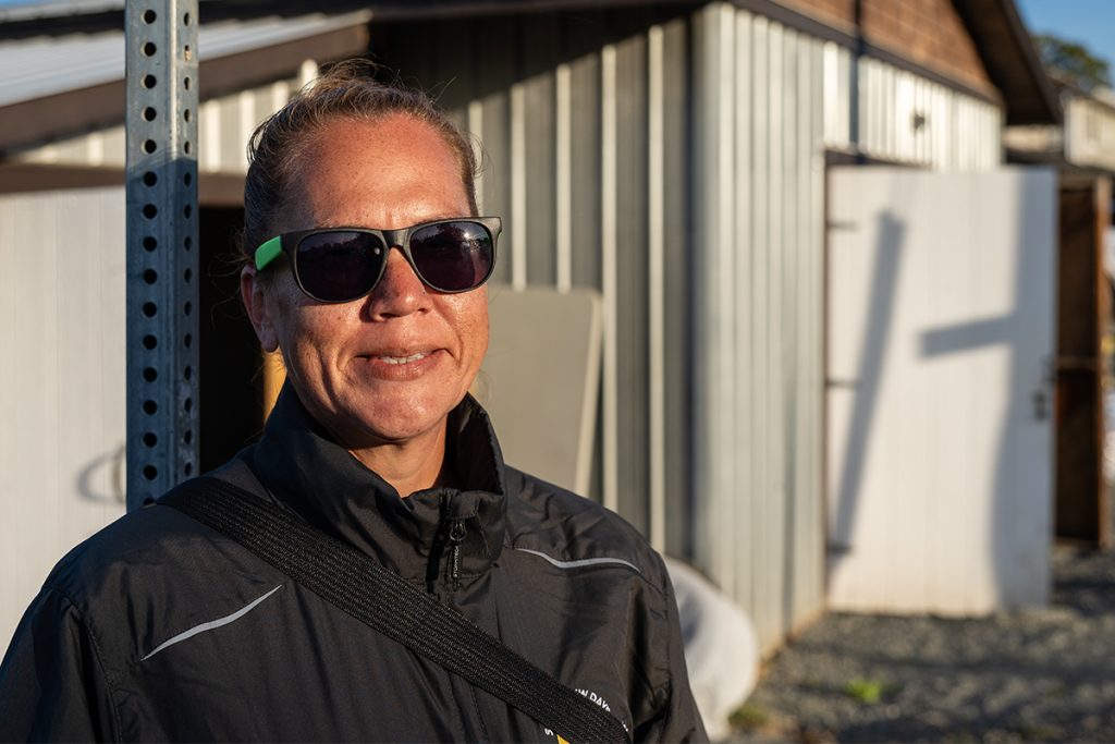 Kate Good stands outside the canoe storage building on Snuneymuxw Reserve #1.