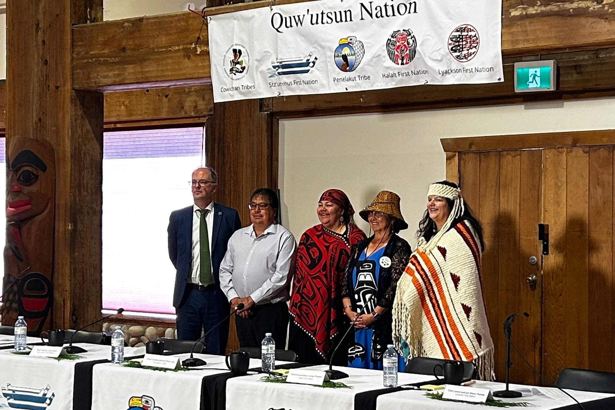 Four Leaders from the Quw’utsun Nation stand with their legal counsel at a press conference announcing the court win.