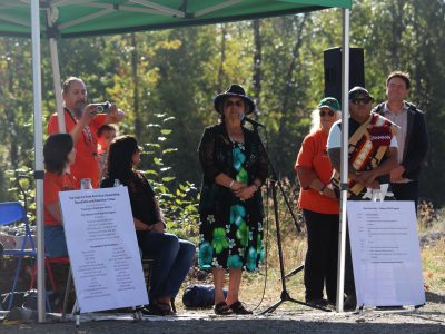 Cowichan Tribes Chief Cindy Daniels standing behind a microphone at Cowichan River Day.