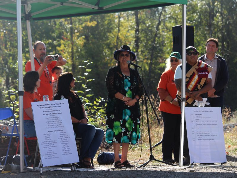 Cowichan Tribes Chief Cindy Daniels standing behind a microphone at Cowichan River Day.