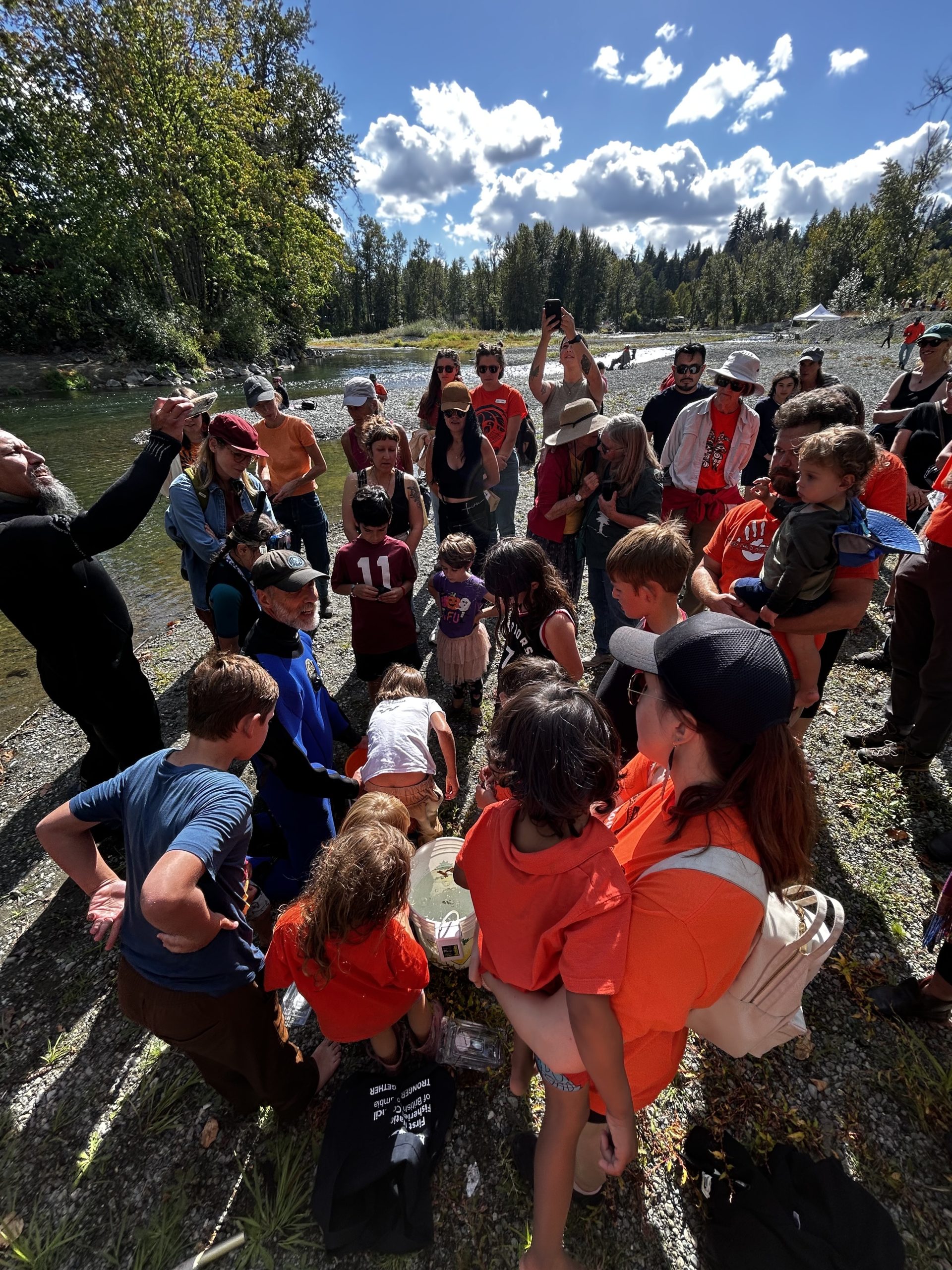 A group of visitors watches a demonstration at Cowichan River Day.