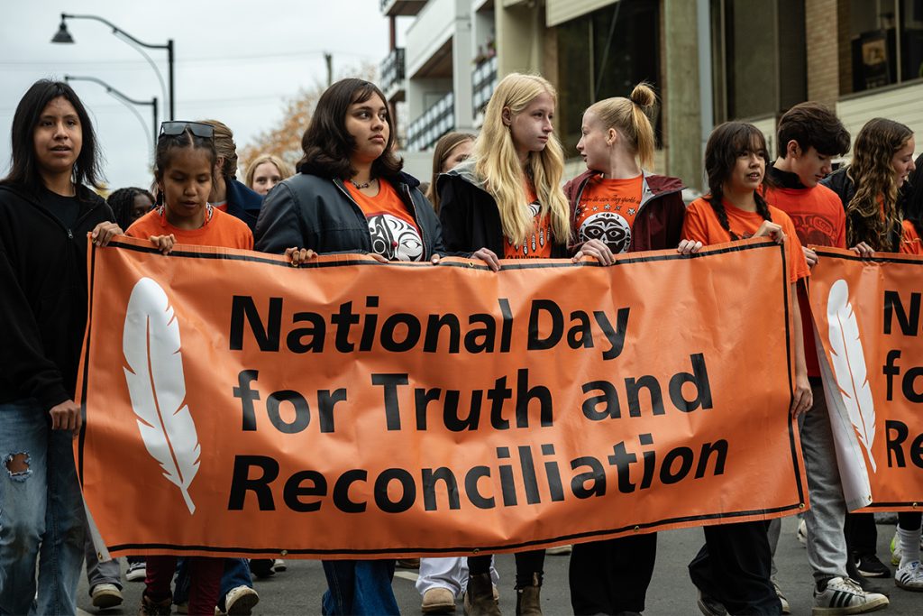 Local students carry the banners at the front of the Every Child Matters march in Downtown Duncan, B.C. on Sept. 30, 2025.