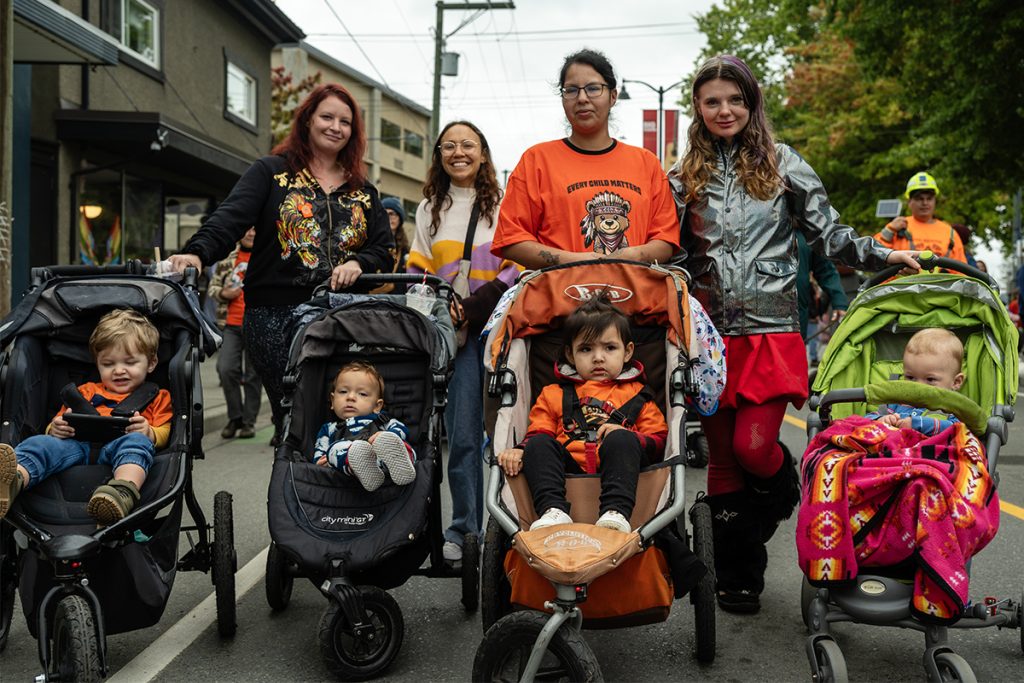 Women walk with young children in strollers in the Every Child Matters March in Duncan, B.C. on Sept. 30, 2025. Photo by Mick Sweetman / The Discourse.