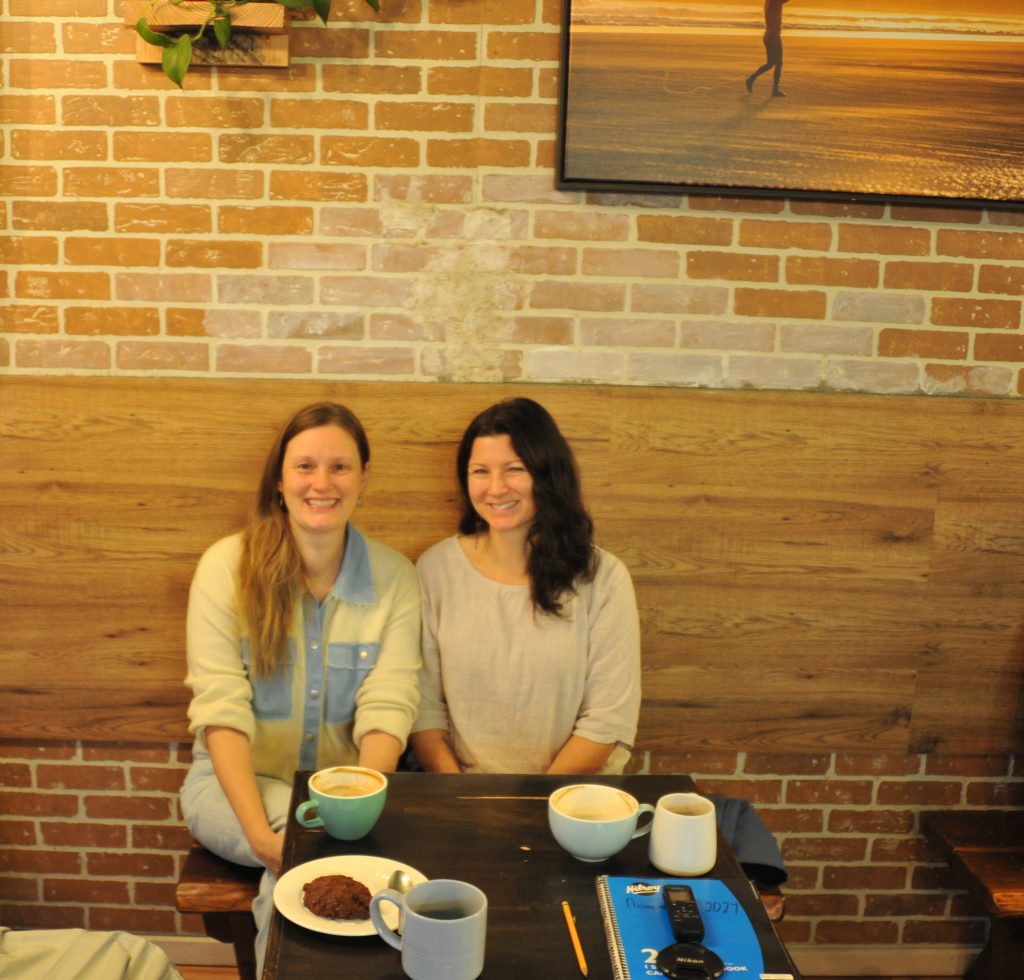 Two women, the organizers of the Courtenay Repair Cafe, sit at a coffee table.