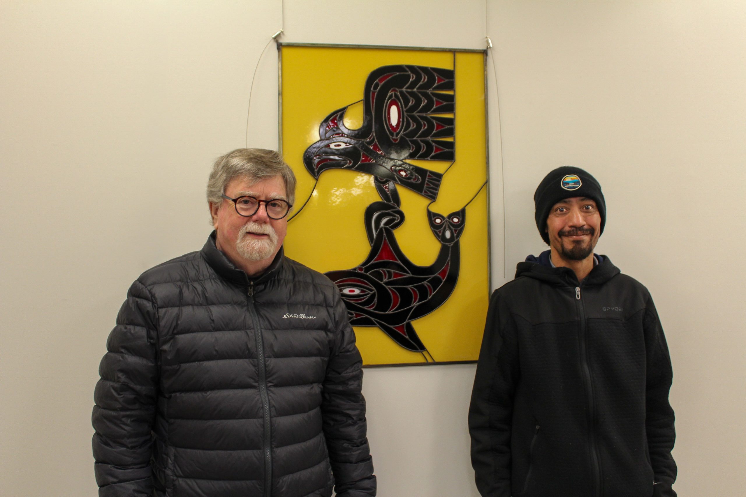 Shawn Johnny and Paul Fogerty stand infront of a collaborative art piece based on Johnny's work, he is one of the artists featured in the Cowichan Valley Art Gallery.