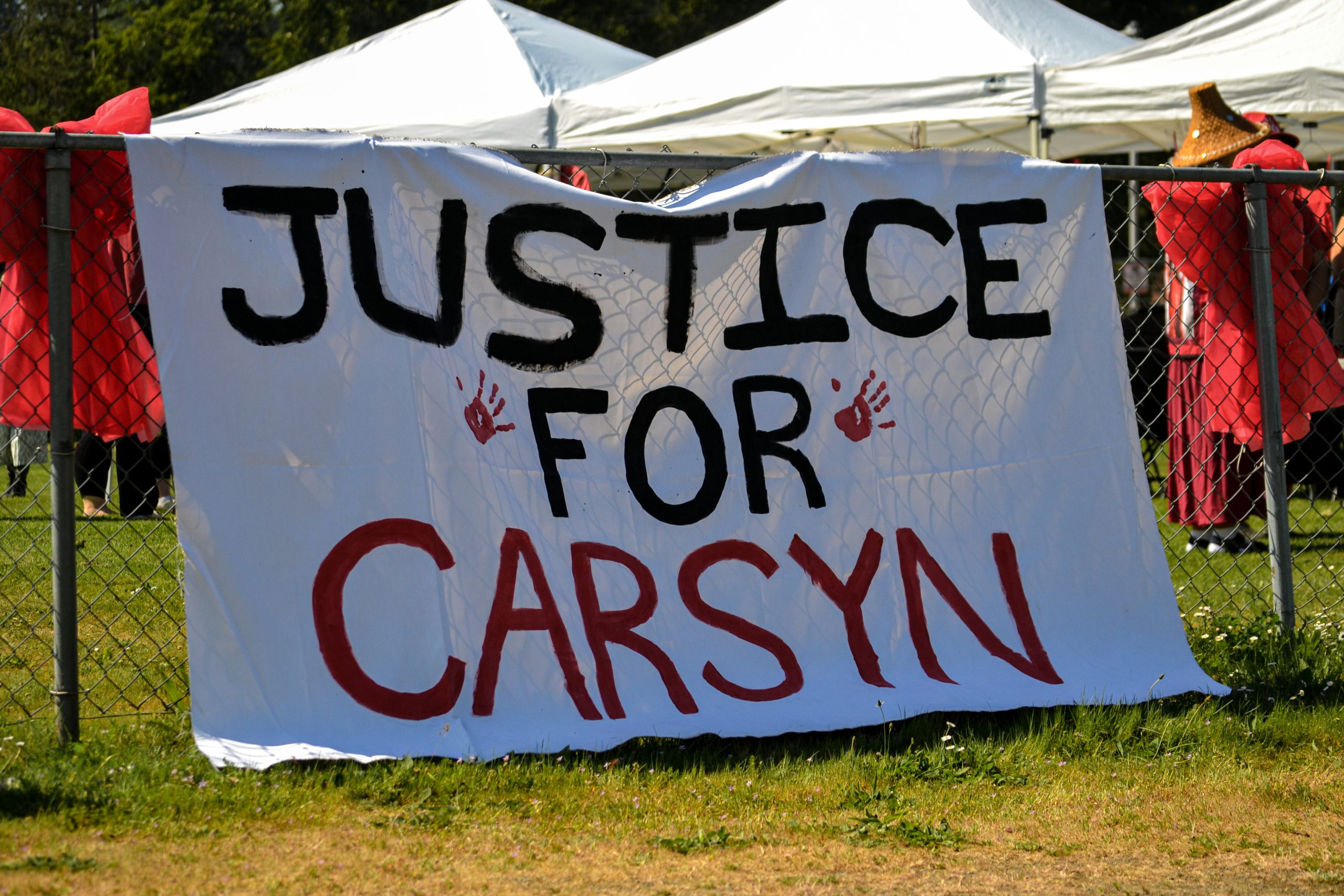 A banner calling for justice for Carson Mackenzie Seaweed at Red Dress Day in the Cowichan Valley.