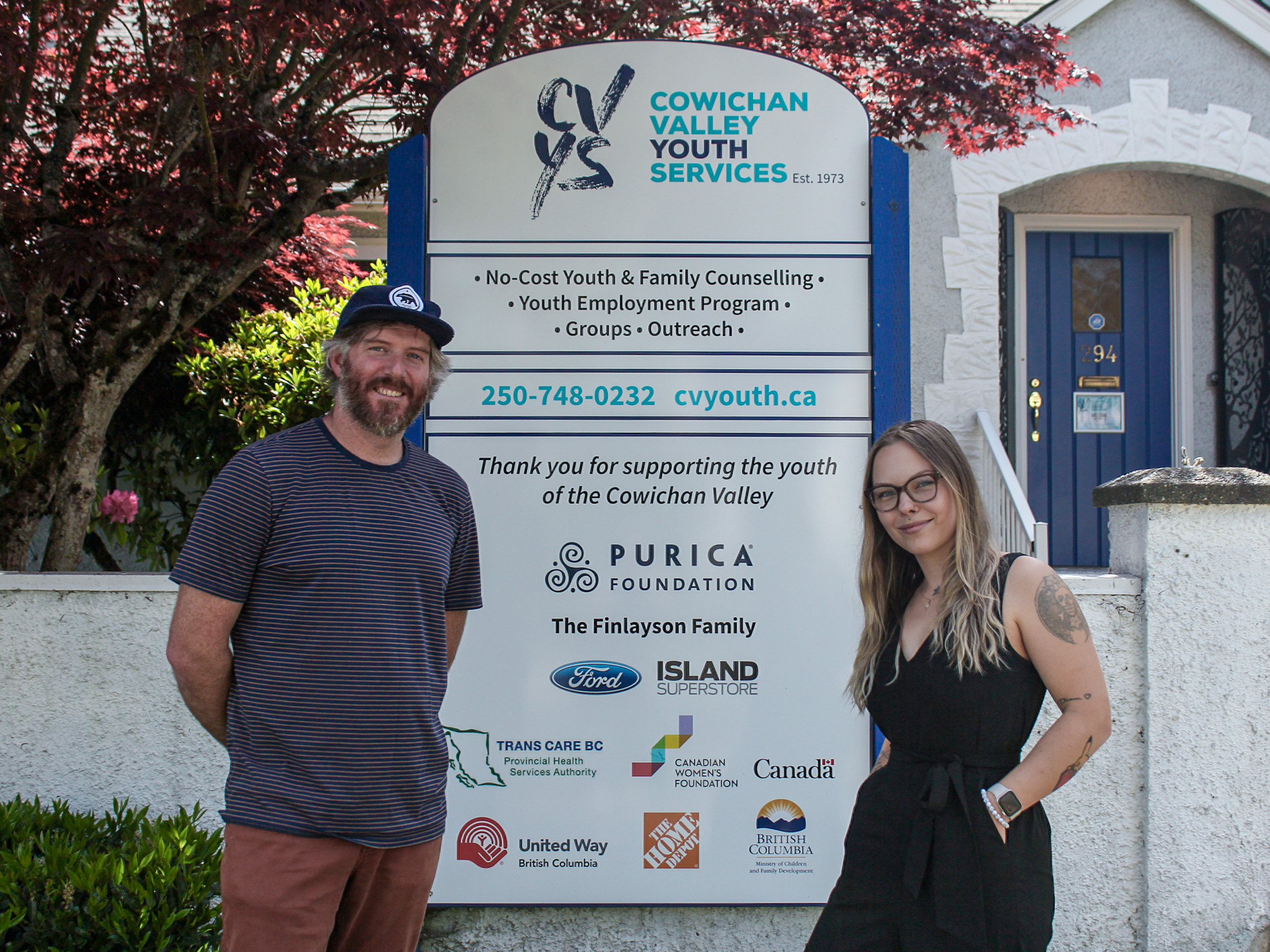 Liam Law and Zoe Lauckner stand in front of Cowichan Valley Youth Services.