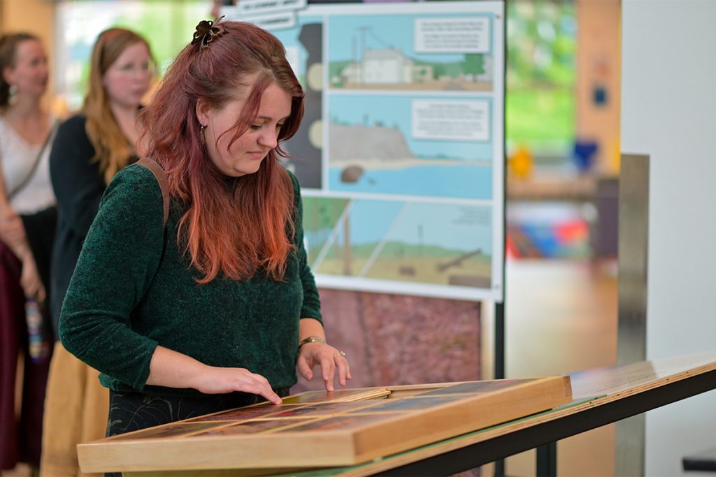 A library patron explores an interactive part of The Great Vancouver Island Land Grab exhibit at the Nanaimo Harbourfront library.