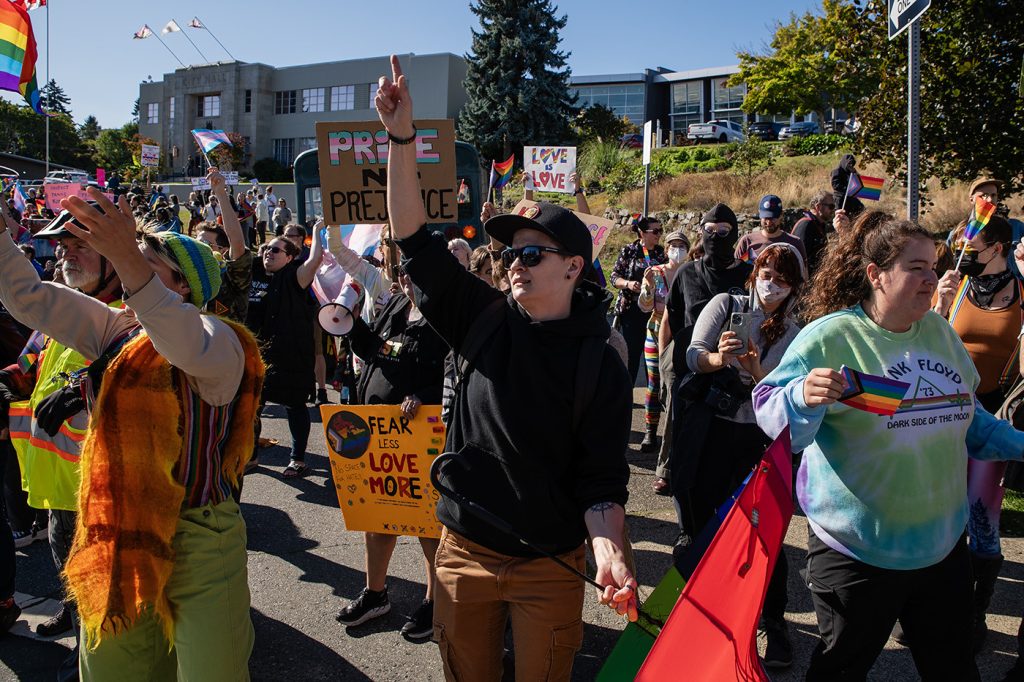 Lauren Semple, centre, helps lead a crowd of pro-SOGI counter protesters in front of Nanaimo City Hall in a rendition of YMCA by The Village People in September 2023.