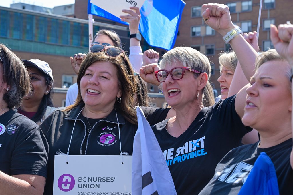 BC Nurses Union president Adriene Gear (left) and United Nurses of Alberta vice president Danielle Larivee chant on the picket line in front of the Nanaimo Regional General Hospital on July 13, 2026.