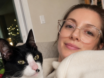 Vivian Albrecht and her foster cat stitch pose for the camera.
